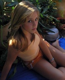 A blond lady posing